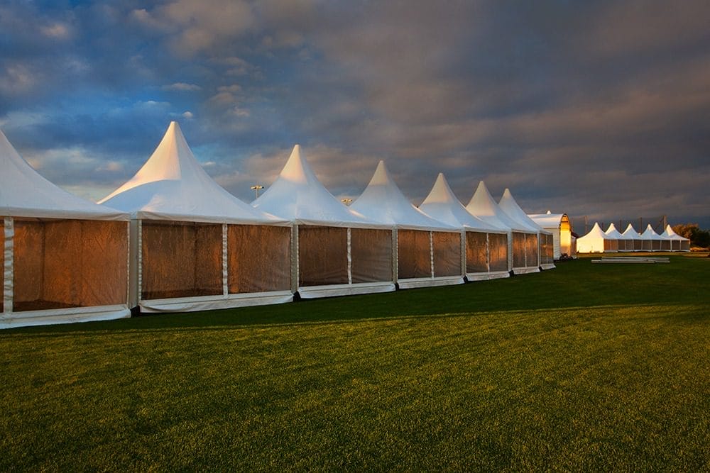 outdoor event tents with storm clouds developing overhead