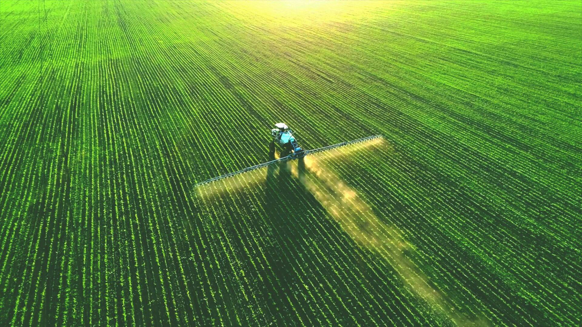 farmer operating machinery to manage crops