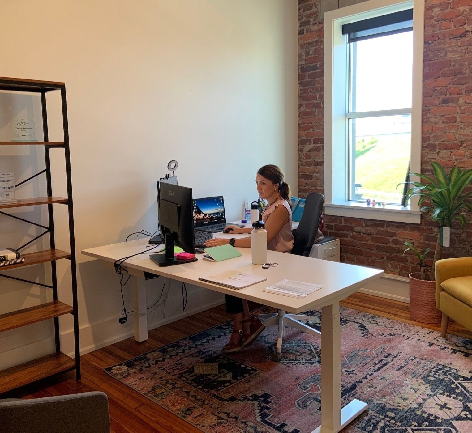 Christy Hartman SVP of finance for Climavision working at her desk at the Nulu office