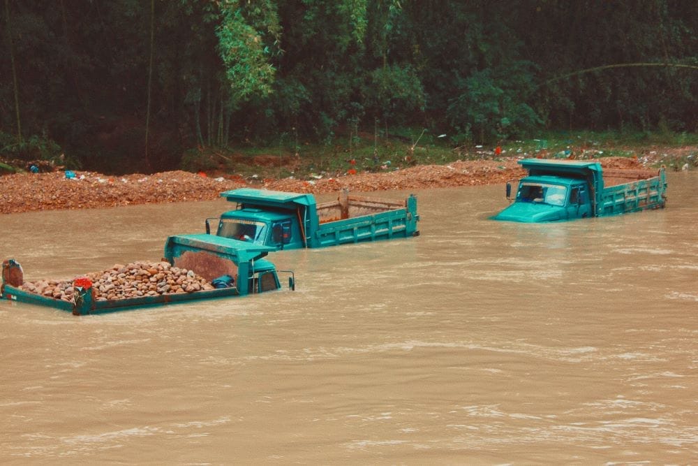 Construction trucks submerged by flood waters