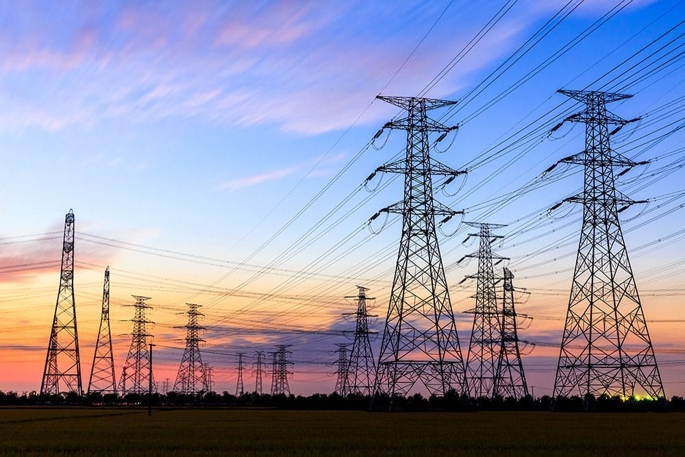 high-voltage power lines at sunset high voltage electric transmission tower