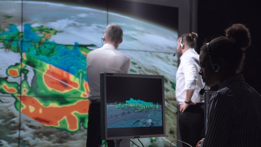 Broadcast crew reviewing hurricane visual